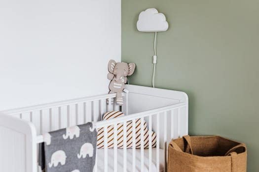 Modern baby room featuring a white crib, soft decor, and pastel accents.